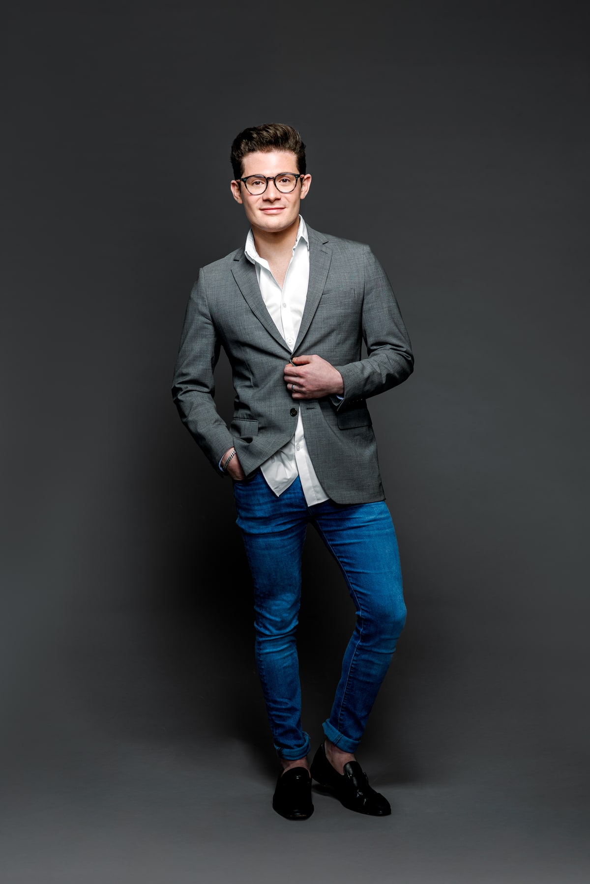 Studio portrait, charcoal backdrop. Brennen Bliss.