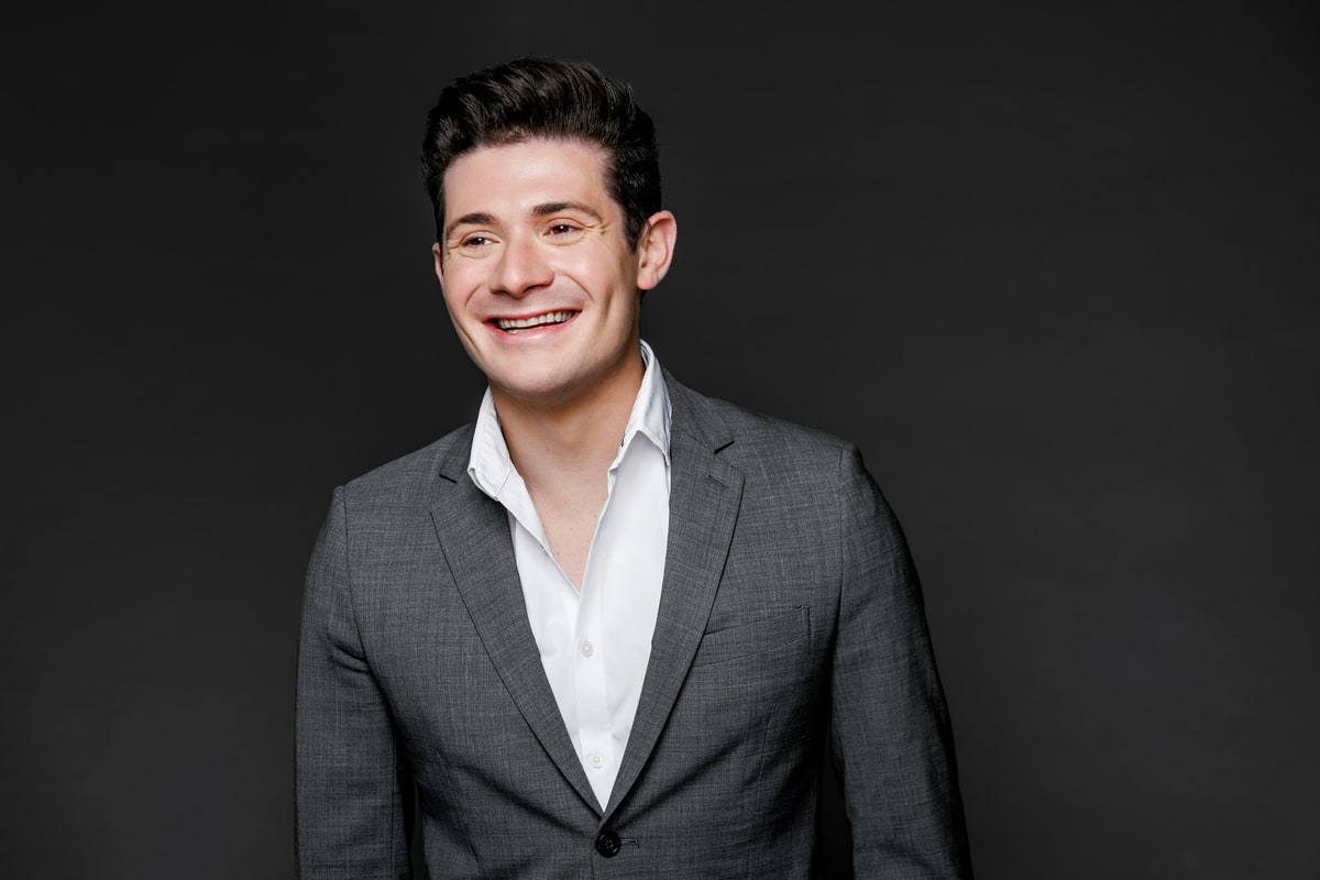 Headshot, grey blazer. Brennen Bliss.